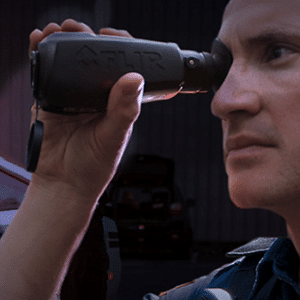 Man seen looking through a Teledyne FLIR Scout LS-X/R thermal monocular.