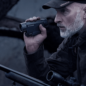 Man shown holding a Pulsar Axion 2 XQ35 thermal monocular.